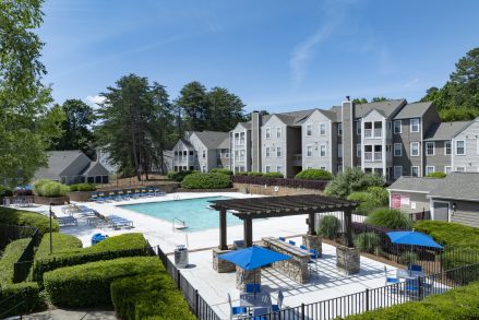 Exterior of Station Heights apartments in Alpharetta Georgia featuring the resort-style pool