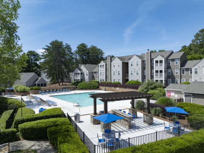 Exterior of Station Heights apartments in Alpharetta Georgia featuring the resort-style pool